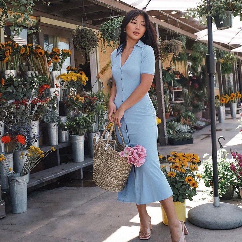 a woman in a dress holding a vase of flowers 