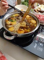 a bowl of soup sitting on a plate 