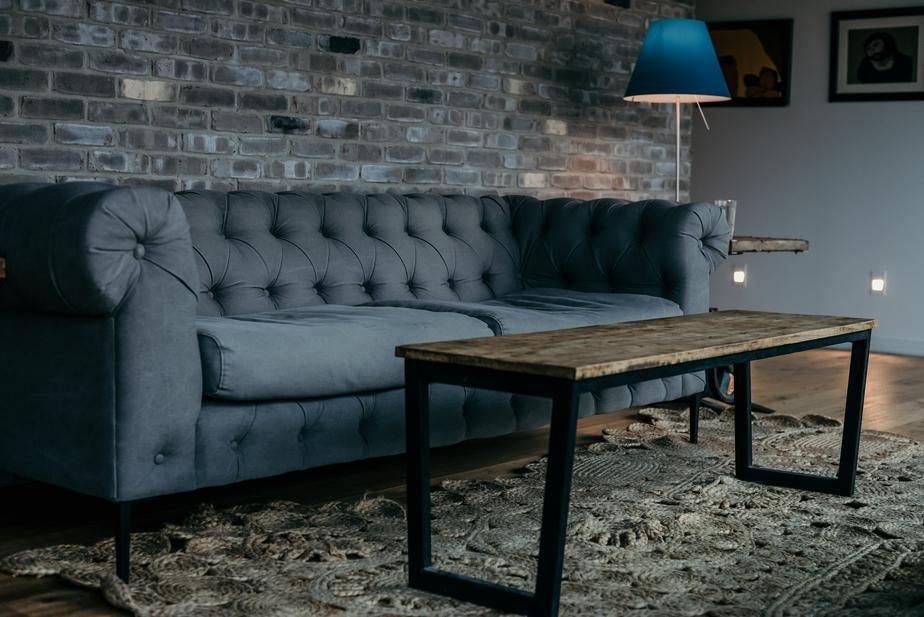 a wooden bench sitting in front of a building 