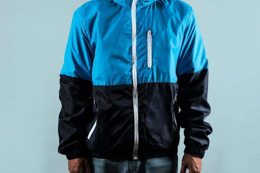 a person in a blue jacket standing on a tennis court 