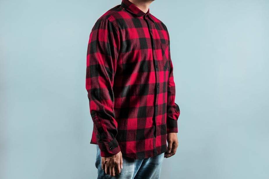 a man is standing on a bench with his skateboard 