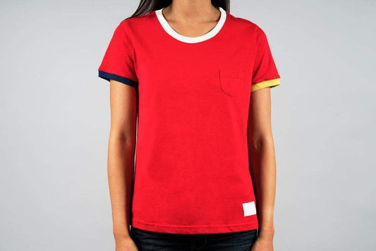 a woman in a red shirt holding a tennis racquet 