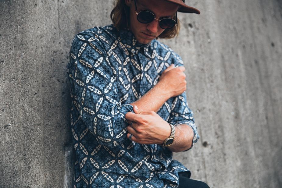 a man sitting on a bench holding a baseball bat 